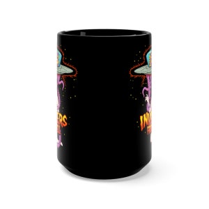 May include: Black ceramic coffee mug with a graphic of a purple alien with a spaceship and the text "Invaders from Hell" on the front.