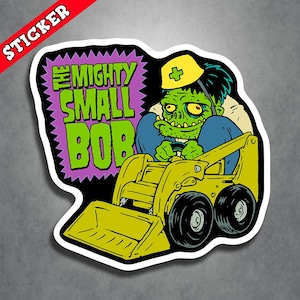 May include: A green cartoon character with a bandage on its head drives a yellow toy construction vehicle. The vehicle has a large scoop in the front. The text "The Mighty Small Bob" is in a purple starburst behind the character.