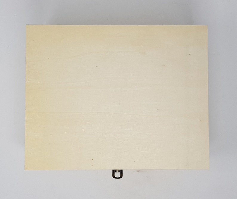 May include: A plain wooden box with a metal latch. The box is light brown and has a smooth surface.