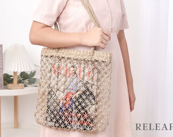 May include: A beige woven tote bag with a magazine inside. The bag has a knotted design and is being carried by a person wearing a pink and white striped dress.