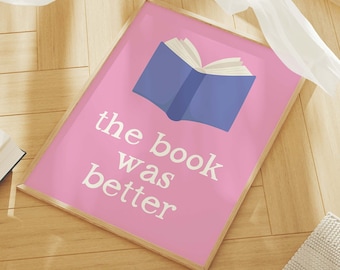May include: A pink framed print with the text "the book was better" and a blue book illustration.