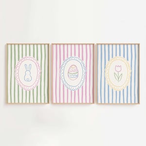 May include: Three printable Easter-themed illustrations in frames. The illustrations are on a striped background and feature a bunny, an egg, and a tulip.