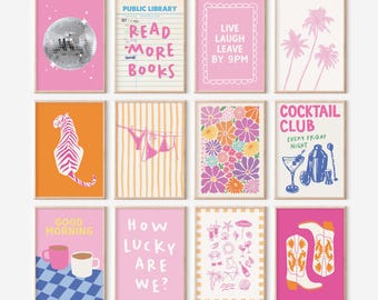 May include: A set of twelve framed art prints with vibrant designs. The prints showcase diverse themes, including a disco ball, text that reads "Read More Books", and a cocktail illustration. The colour scheme includes pink, orange, and white.