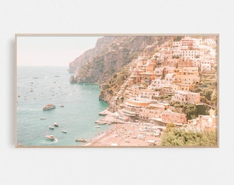 May include: A panoramic view of a coastal town built into a cliffside. The town is a mix of white and pastel-colored buildings with terracotta roofs. The town is nestled between a turquoise blue sea and a rocky cliff.