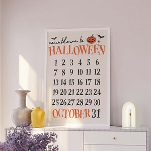 May include: A white framed printable countdown to Halloween with a black and orange pumpkin illustration. The numbers 1 through 30 are listed in rows, with "OCTOBER 31" at the bottom.