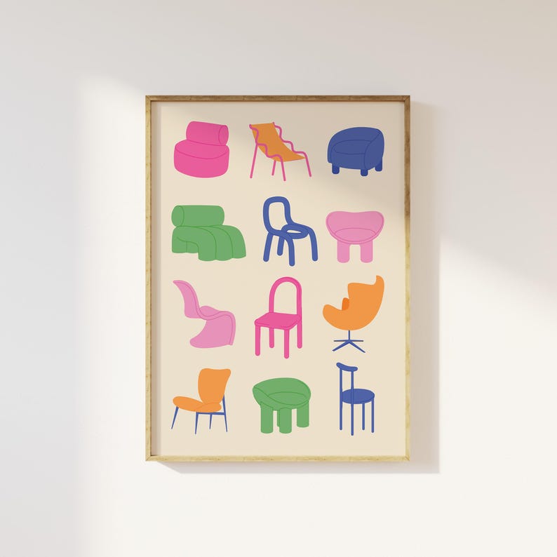 May include: A framed print featuring a collection of colorful, stylized chairs. The chairs are depicted in various shapes and colors, including pink, orange, blue, and green, against a cream-colored background. The artwork is framed in a simple, light brown wooden frame.