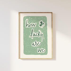 May include: A green and white print with the text "how lucky are we" and a green shamrock.