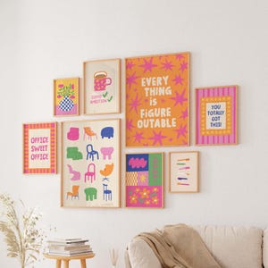 May include: A gallery wall of framed art prints with colorful designs and motivational quotes. The prints feature text like "Office Sweet Office" and "Everything is Figure Outable." The color palette includes pink, orange, blue, and green.