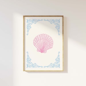 Puede incluir: Una concha rosa con un marco azul adornado. El marco tiene un dise&ntilde;o decorativo en las esquinas.