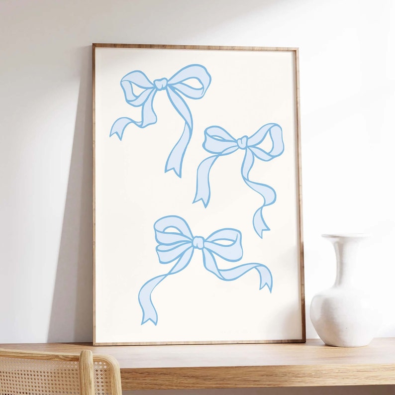 May include: A printable art print featuring three light blue bows on a white background.