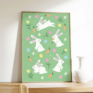 May include: A green background with white bunnies, carrots, and colorful Easter eggs. The bunnies are hopping and holding carrots. This is a digital print for a nursery or child's room.