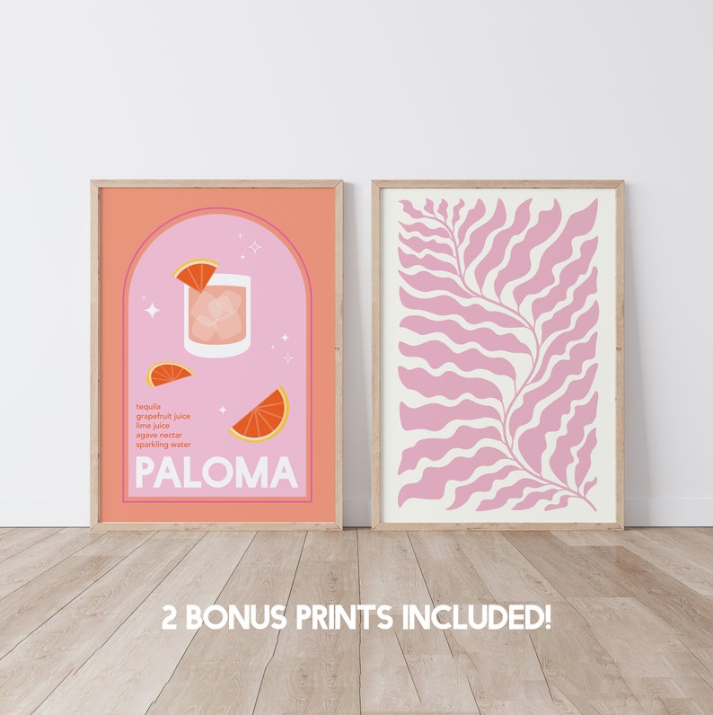 May include: Two framed prints, one with a pink background and a cocktail illustration with the text "PALOMA" and the ingredients listed, and the other with a pink and white abstract leaf design.