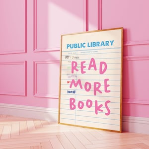 May include: A vintage-style public library card with the text "READ MORE BOOKS" in pink lettering. The card has a date due field with the date "OCT 1 2 1966" filled in.