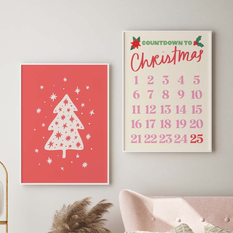 May include: Two framed prints with a Christmas theme. The first print features a white stylized Christmas tree with white stars on a red background. The second print has a white background with the text "COUNTDOWN TO Christmas" in pink and a list of numbers 1-25 in pink.