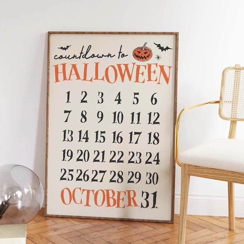 May include: A countdown to Halloween sign with a black and orange pumpkin and bats. The sign has the numbers 1 through 30 and the text "OCTOBER 31".