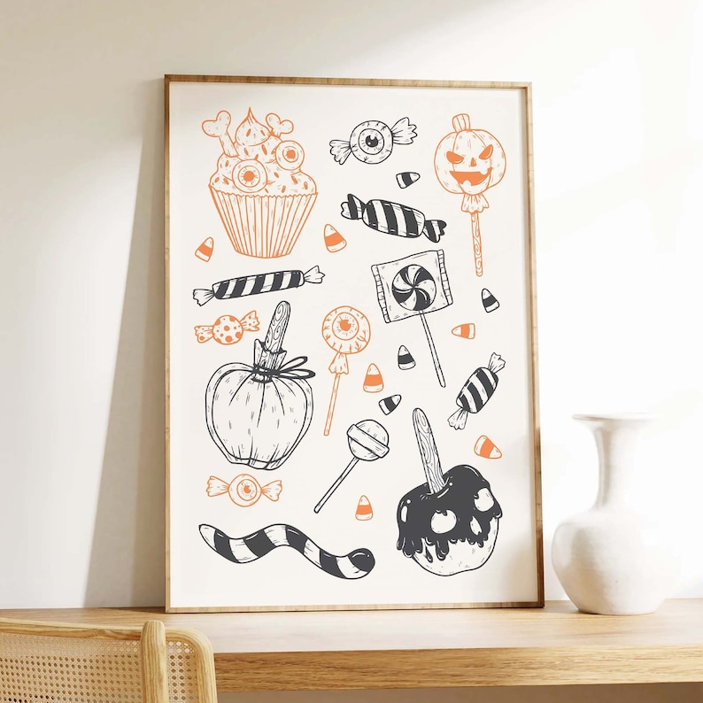 K&ouml;nnte beinhalten: Eine Schwarzwei&szlig;illustration von Halloween-Leckereien, darunter ein Cupcake mit Augen, ein Apfel in Zuckerguss, ein Lollipop und ein K&uuml;rbis mit einem Jack-o'-Lantern-Gesicht.