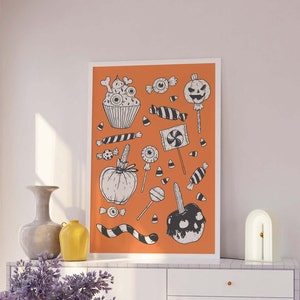 May include: An orange background with black and white illustrations of Halloween treats, including a cupcake, candy corn, a pumpkin, a candy apple, and a jack-o-lantern.