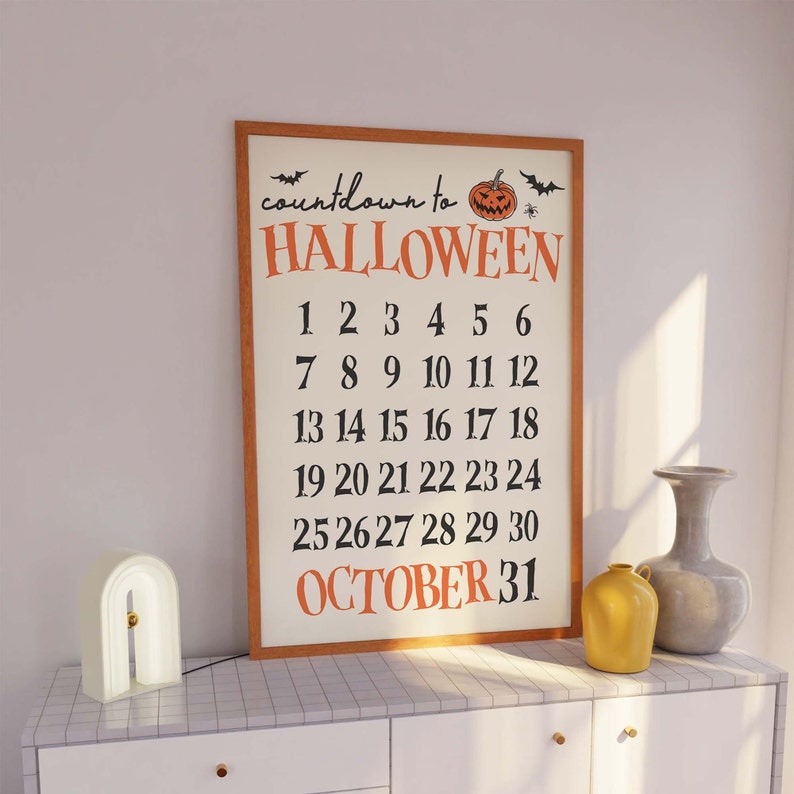 May include: A framed countdown to Halloween poster with a pumpkin and bats. The poster features the numbers 1 through 30 and the text "OCTOBER 31".