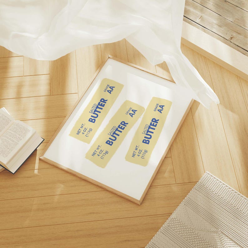 May include: Three yellow and blue rectangular labels with the text "SALTED BUTTER AA" and "NET WT. 4 OZ (113g)" on a white background in a wooden frame.