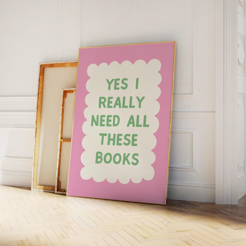 May include: Pink and white printable wall art with the text "YES I REALLY NEED ALL THESE BOOKS" in green.