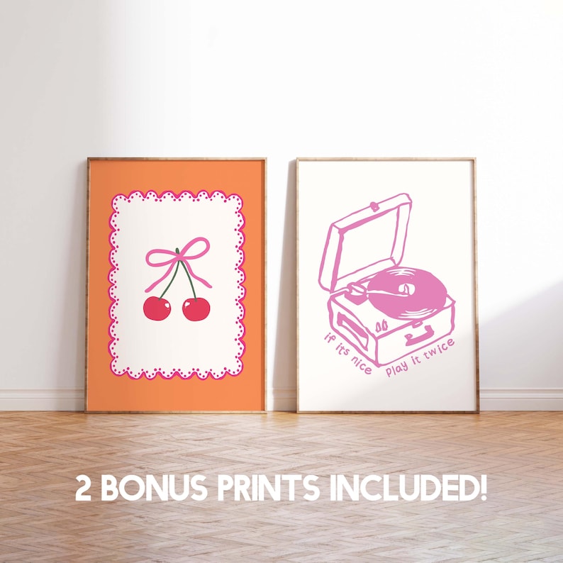 May include: Two framed art prints. One features a cherry design with a pink bow and scalloped border on an orange background. The other print shows a pink record player with the text "If it's nice, play it twice."