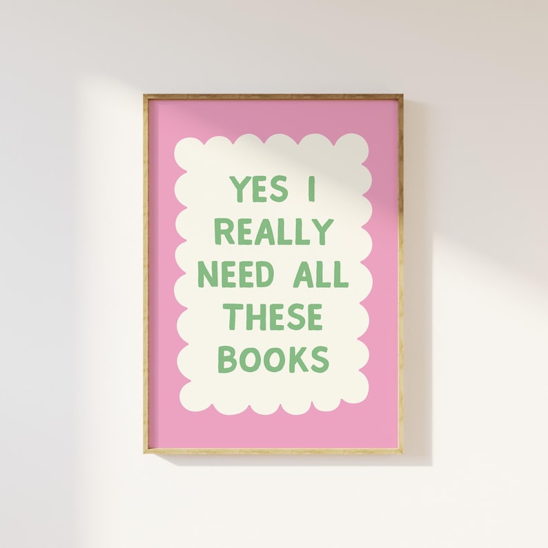 May include: A pink and white printable wall art print with a green text overlay that reads "Yes I really need all these books".