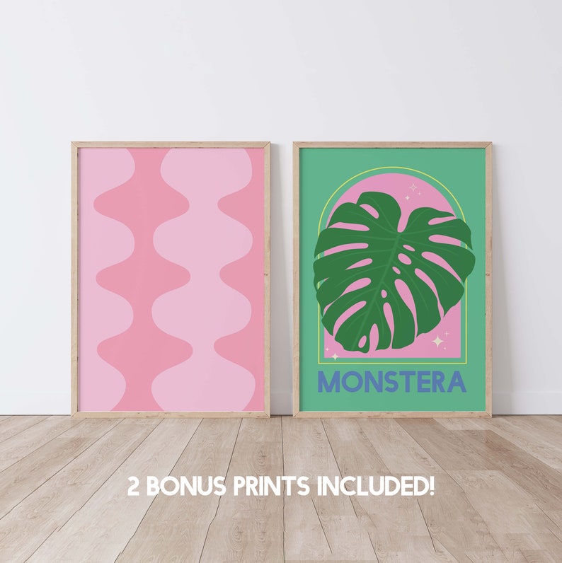 May include: Two framed prints, one with a pink and white abstract pattern and the other with a green monstera leaf on a pink background. The print with the monstera leaf has the word "MONSTERA" in blue text.