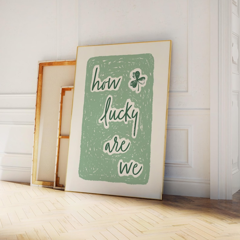 May include: A green and white print with the text "how lucky are we" and a four-leaf clover graphic.