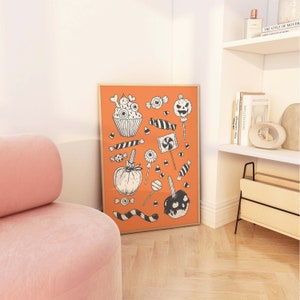 May include: An orange poster with black and white illustrations of Halloween candy, including a cupcake, a pumpkin, candy corn, lollipops, and a caramel apple.
