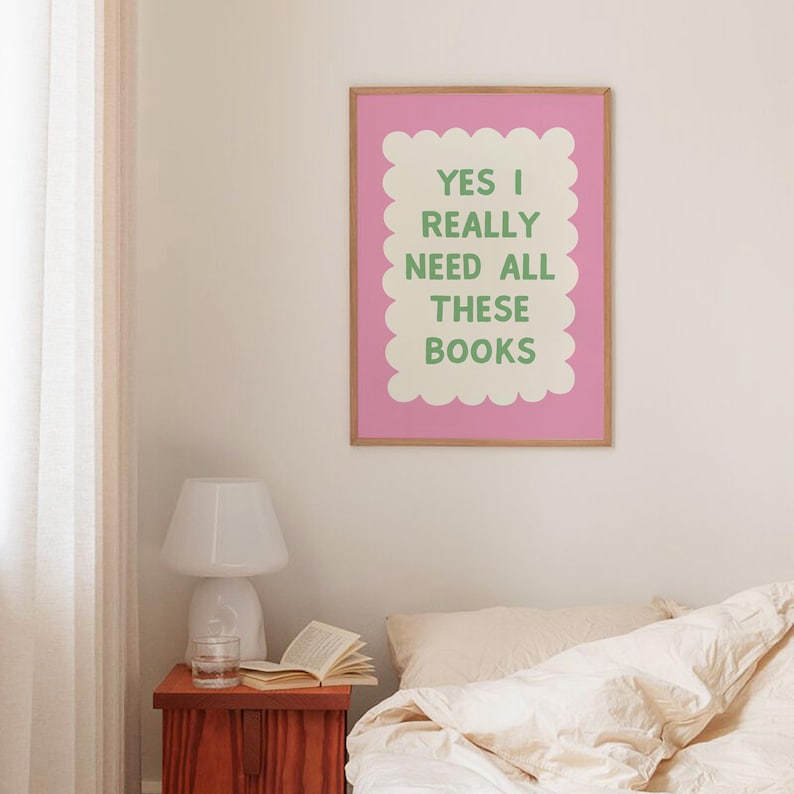 May include: A pink and white framed print with a green border and the text "YES I REALLY NEED ALL THESE BOOKS" in green letters.
