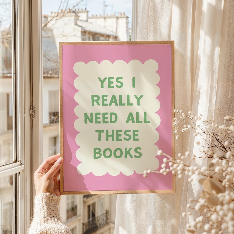 May include: Pink framed print with a white and green text graphic that reads "Yes I really need all these books".