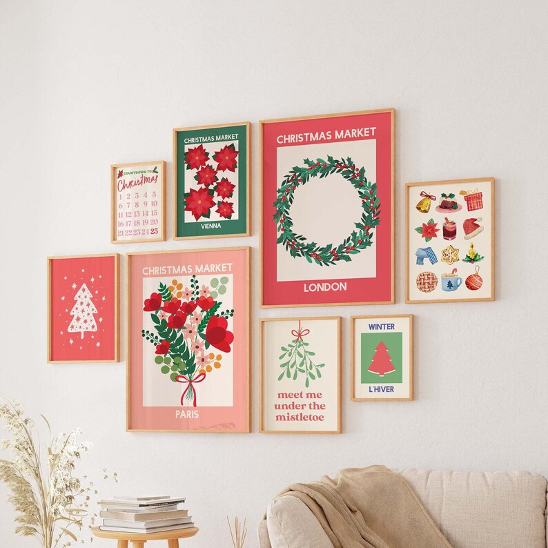 May include: A collection of eight framed prints with a Christmas theme. The prints feature illustrations of Christmas trees, wreaths, poinsettias, mistletoe, and other festive symbols. The prints are in a variety of colours, including red, green, white, and gold. The prints are arranged in a grid pattern on a white wall.
