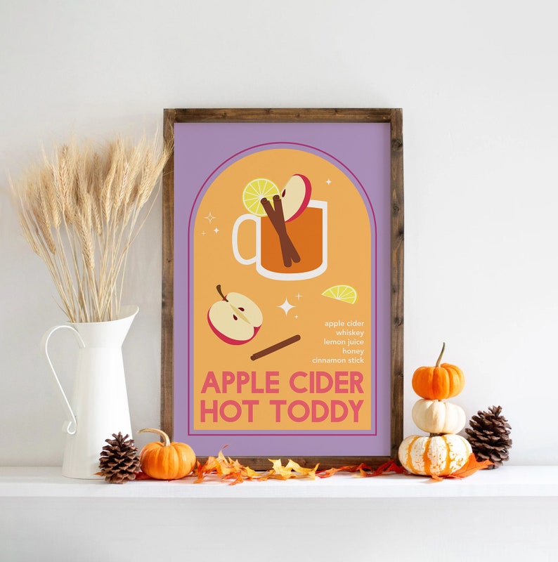 May include: A printable poster with a purple background and an orange arch. The arch contains a glass of apple cider hot toddy with a cinnamon stick, apple slices, and a lemon wedge. The text "APPLE CIDER HOT TODDY" is below the glass. The ingredients are listed below the text: apple cider, whiskey, lemon juice, honey, cinnamon stick.