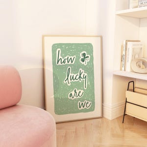May include: A green and white poster with the text "how lucky are we" and a green shamrock.
