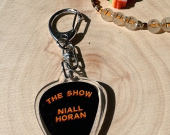 PRE ORDER NH Keychain - Guitar Pick “The Show”