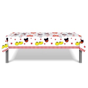 May include: White plastic tablecloth with a red and yellow border. The tablecloth features a repeating pattern of Mickey Mouse heads, red stars, and yellow shoes.