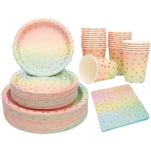 May include: A set of pastel ombre paper plates, cups, and napkins with gold polka dots. The plates and cups are stacked, and the napkins are folded. The set is perfect for a party or celebration.