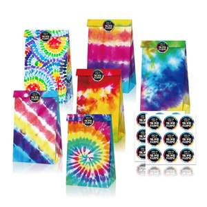 May include: A collection of colorful tie-dye paper gift bags with various patterns, including spirals and stripes. Each bag has a folded top and a circular sticker that reads "Join us for a Tie Dye Party!" A sheet of matching stickers is also included.