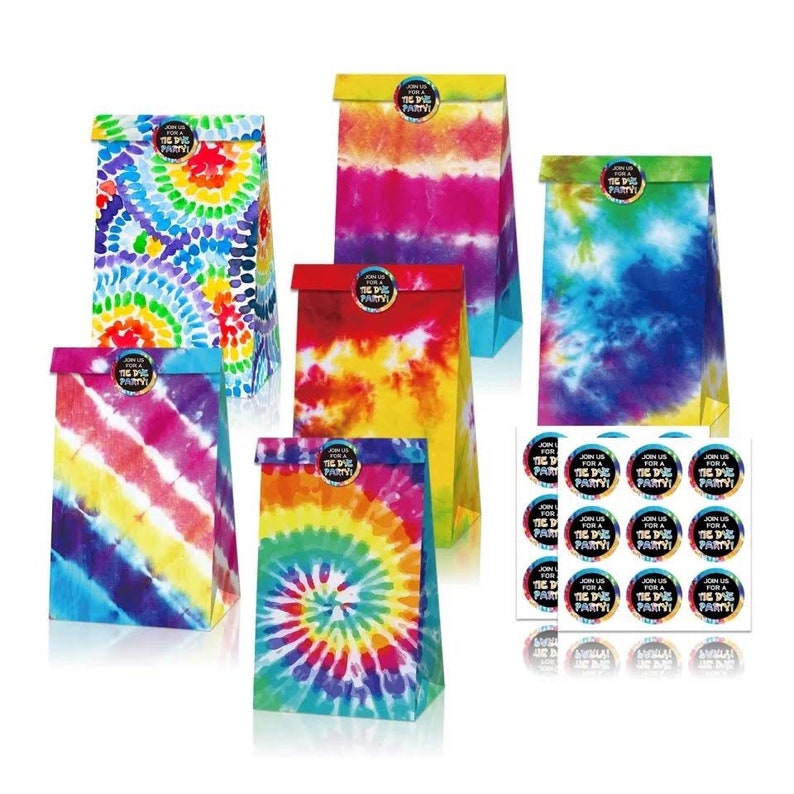 May include: A collection of colorful tie-dye paper gift bags with various patterns, including spirals and stripes. Each bag has a folded top and a circular sticker that reads "Join us for a Tie Dye Party!" A sheet of matching stickers is also included.