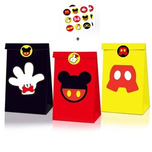 May include: Three small paper gift bags featuring Mickey Mouse character designs. The bags are black, red, and yellow. Each bag has a round sticker with a Mickey Mouse character on it. The stickers are yellow with red and black details.