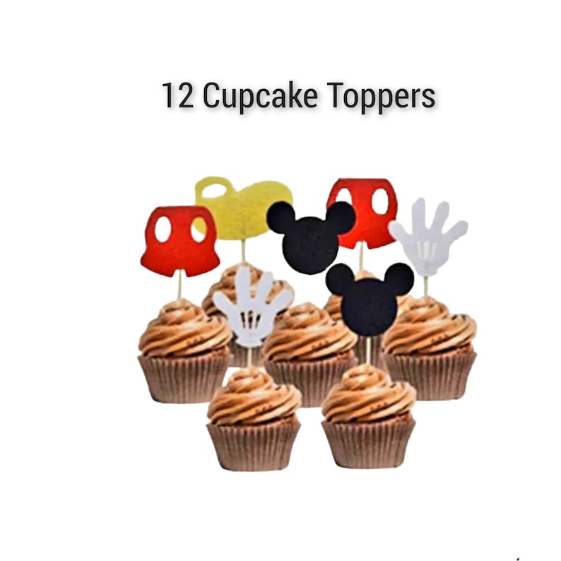 May include: Twelve cupcake toppers featuring Mickey Mouse characters. The toppers are made of felt and include Mickey Mouse ears, gloves, and shorts in red, black, white, and yellow.