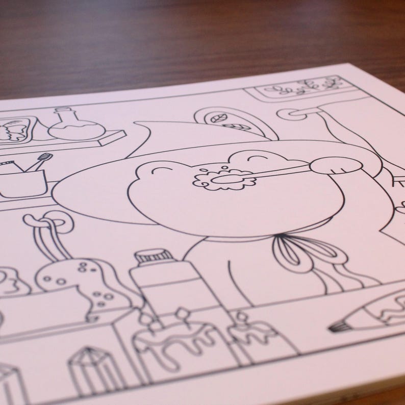 May include: A black and white line drawing of a cartoon frog wearing a witch's hat and holding a toothbrush. The frog is surrounded by various objects, including a bottle of toothpaste, a crystal, and a cake.