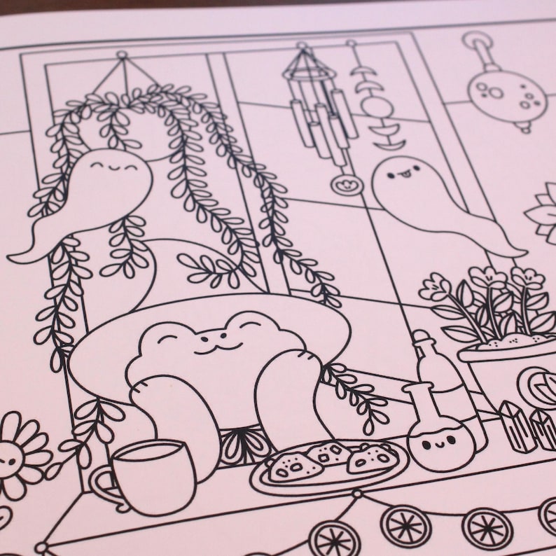 May include: A black and white line drawing of a frog sitting in a window with a plant, a ghost, and a wind chime. The frog is wearing a witch's hat and holding a cup of tea. There are cookies on a plate in front of the frog.