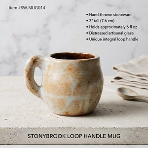 May include: A hand-thrown stoneware mug with a distressed artisanal glaze and an integral loop handle. The mug is 3 inches tall and holds 6 fluid ounces. Text includes Item #SW-MUG014 and STONYBROOK LOOP HANDLE MUG.