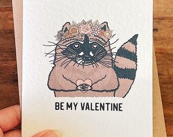 Be My Valentine - Raccoon Valentines Day Greetings Card with Cute Flower Crown Heart Illustration - A6 Greeting Card