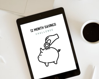 May include: A digital tablet screen displaying a 12 Month Savings Challenge graphic. The graphic features a black and white illustration of a piggy bank with a hand placing a coin in the slot.