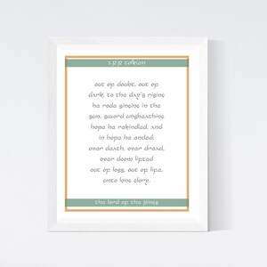May include: A framed print with a quote by J.R.R. Tolkien in a white frame with a green and orange border. The quote reads: "Out of doubt, out of dark, to the day's rising, he rode singing in the sun, second unshattering hope he rakindlad, and in hope he andal; over death, over draad, over doom liptad out of loss, out of lipa, unto long glory." The bottom of the print reads "The Lord of the Pines".