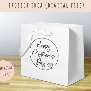 May include: White gift bag with a black circle and the text "Happy Mother's Day" with a pink heart.