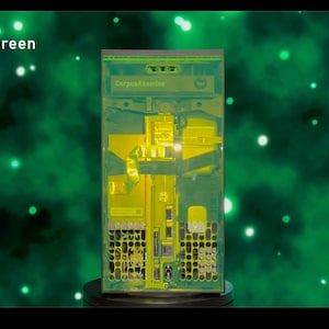 May include: A clear green computer case with the text "Corpus Absconditum" on the front. The case is illuminated from the inside, showing the internal components.