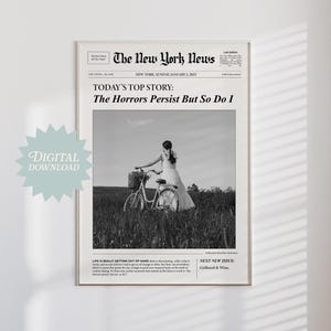 以下が含まれることがあります： ヴィンテージ新聞風の白黒デジタルプリント。見出しは「The Horrors Persist But So Do I」と書かれています。画像には、野原で自転車に乗っている人が写っています。「Digital Download」の文字も表示されています。